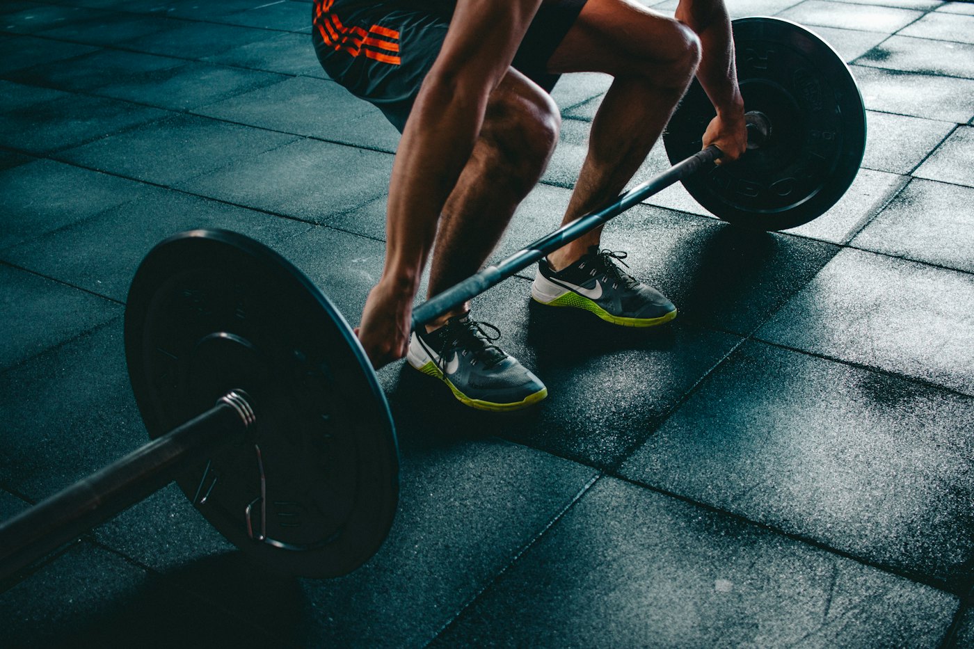 Person lifting a barbell in a gym